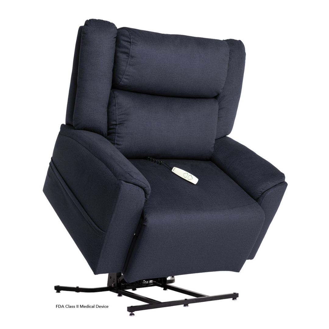 The Pride Mobility Evolution Collection Power Lift Recliners is a dark blue, plush chair with padded armrests and backrest, partially raised with a remote on the seat; text at the base reads “FDA Class II Medical Device.”.