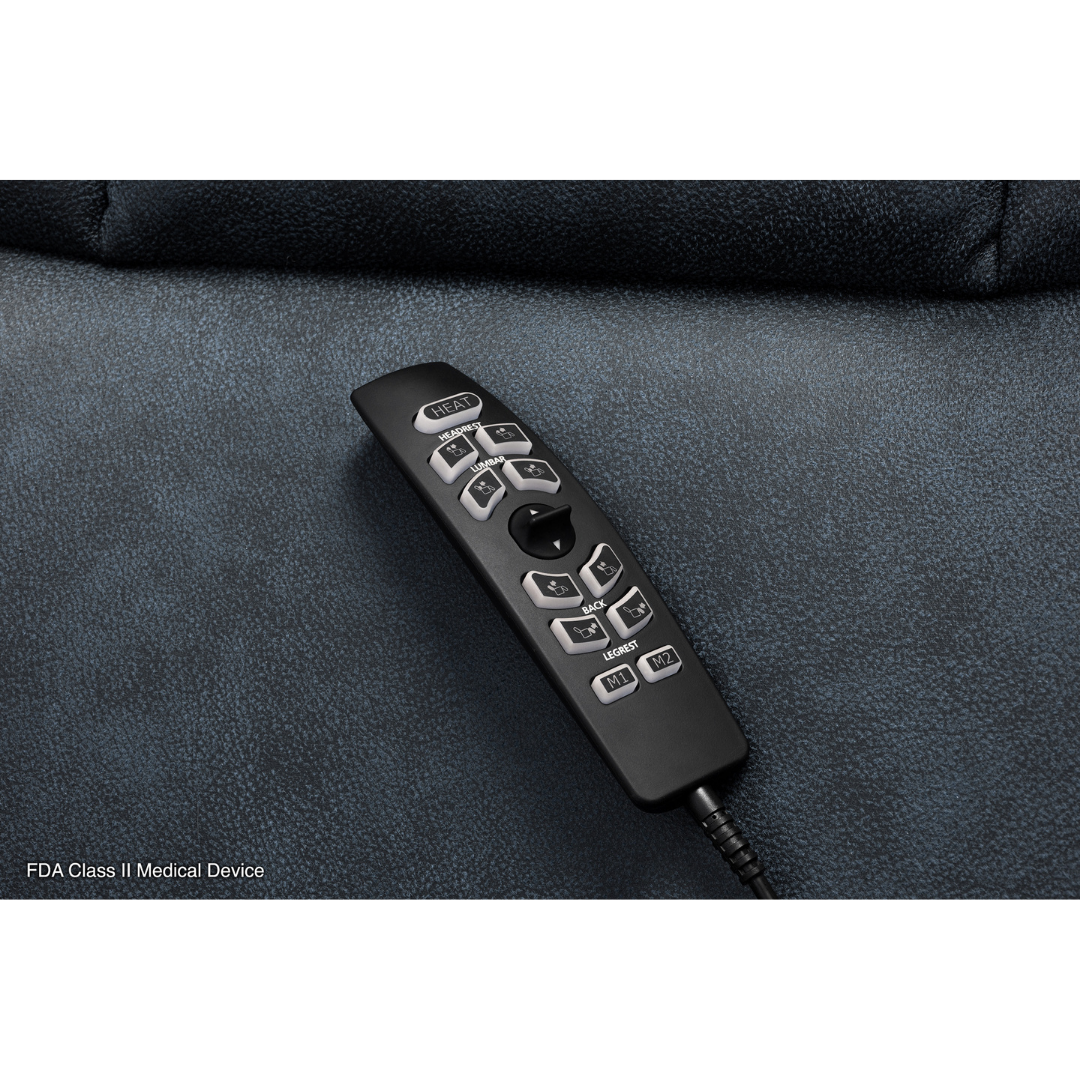 A black remote with gray buttons and a cord rests on the dark blue upholstery of a Pride Mobility VivaLift! Radiance Recliner with Lift Assist & Heat. FDA Class II Medical Device appears in the lower left corner.