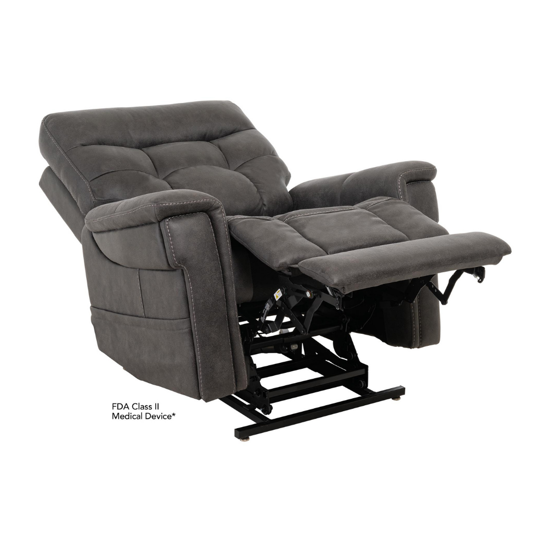 The Pride Mobility VivaLift! Radiance Recliner with Lift Assist & Heat is a dark gray power recliner with padded armrests and backrest, infinite positioning, shown partially lifted with footrest extended; FDA Class II medical device.