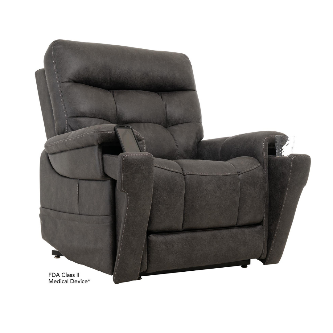 The Pride Mobility VivaLift! Radiance Recliner with Lift Assist & Heat is a dark gray upholstered power recliner featuring thick cushioning, wide armrests, side remote pocket, infinite positioning, and lift assist for medical or therapeutic use.
