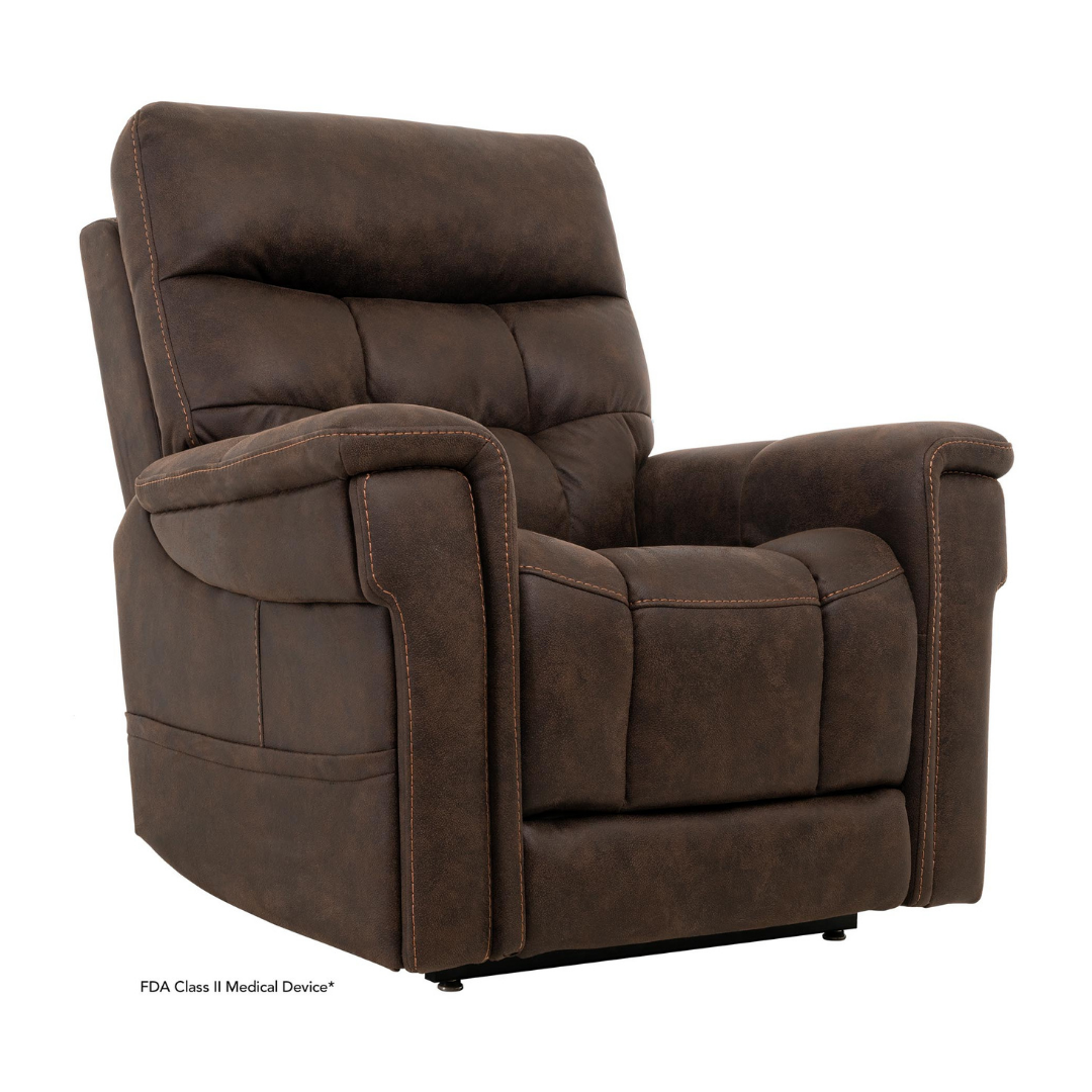 The Pride Mobility VivaLift! Radiance Recliner with Lift Assist & Heat is a brown padded power chair featuring plush cushions, visible stitching, a high back, wide armrests, and infinite positioning. The chair is slightly angled to the right.