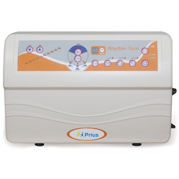 The Prius Rhythm Turn LAL Alternating Pressure Mattress System is a white medical device with an orange and blue display panel labeled Rhythm-Turn. It includes buttons, indicators, and a digital screen displaying the Prius logo while offering lateral rotation therapy.