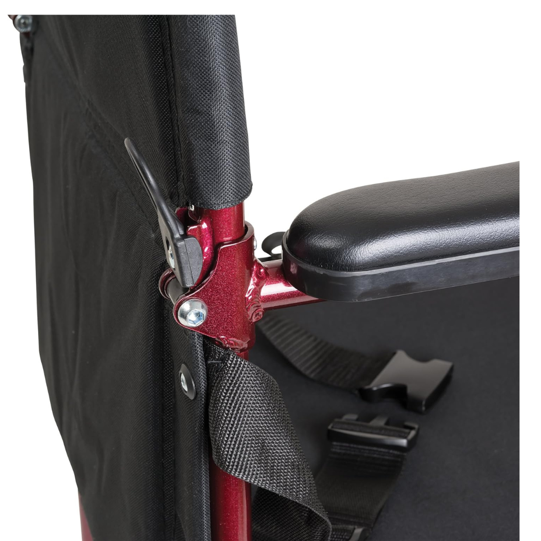 Close-up view of the ProBasics Aluminum Lightweight Transport Chair’s side, featuring a black armrest, red aluminum frame, folding hinge lever, seatbelt strap, and black fabric backrest.