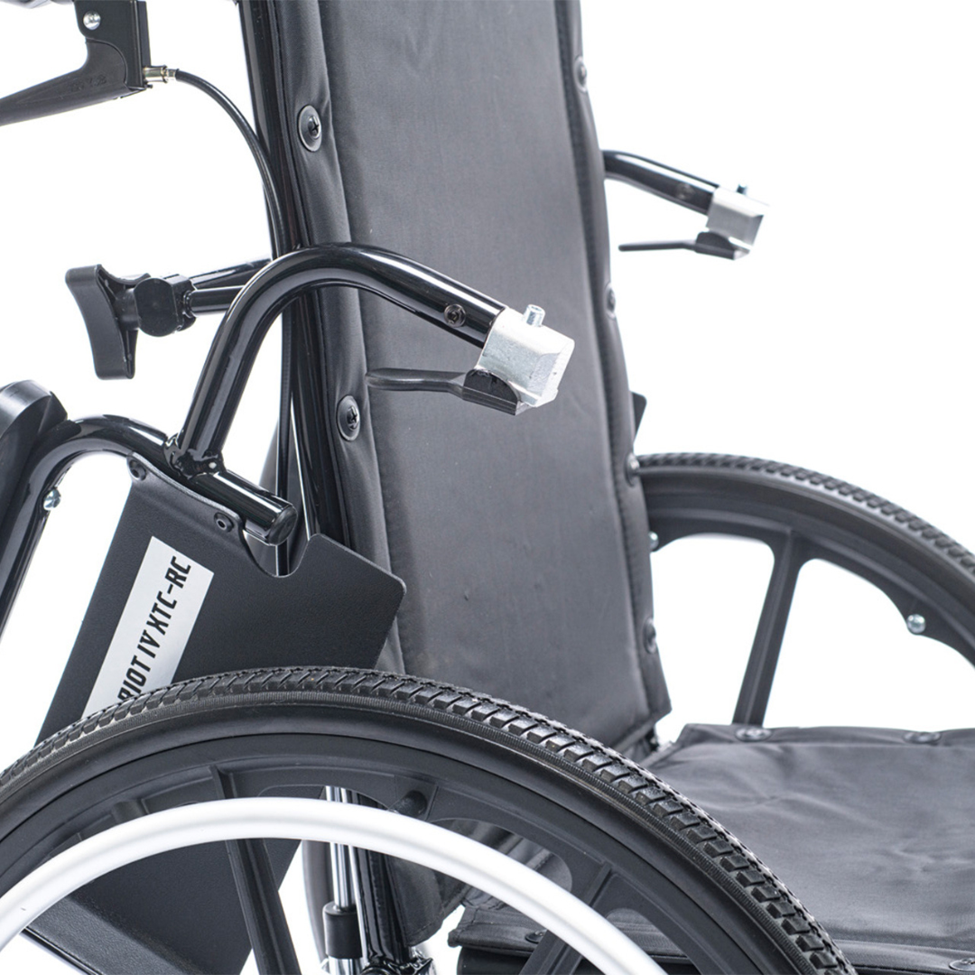 Close-up view of the Proactive Chariot IV XTC-RC Pediatric Folding Reclining Wheelchair, featuring its black carbon steel frame, armrests, backrest, rear wheel, and part of the seat against a white background.