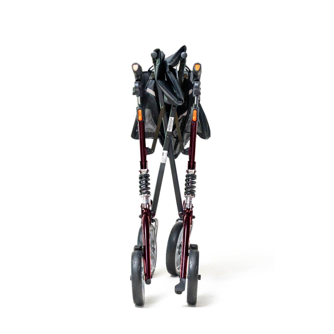 The Probasics Ascent XR™ Euro-Style Bariatric Rollator with Suspension, a foldable heavy-duty walker with shock-absorbing suspension and four wheels, is shown collapsed with a dark frame and black seat against a plain white background.