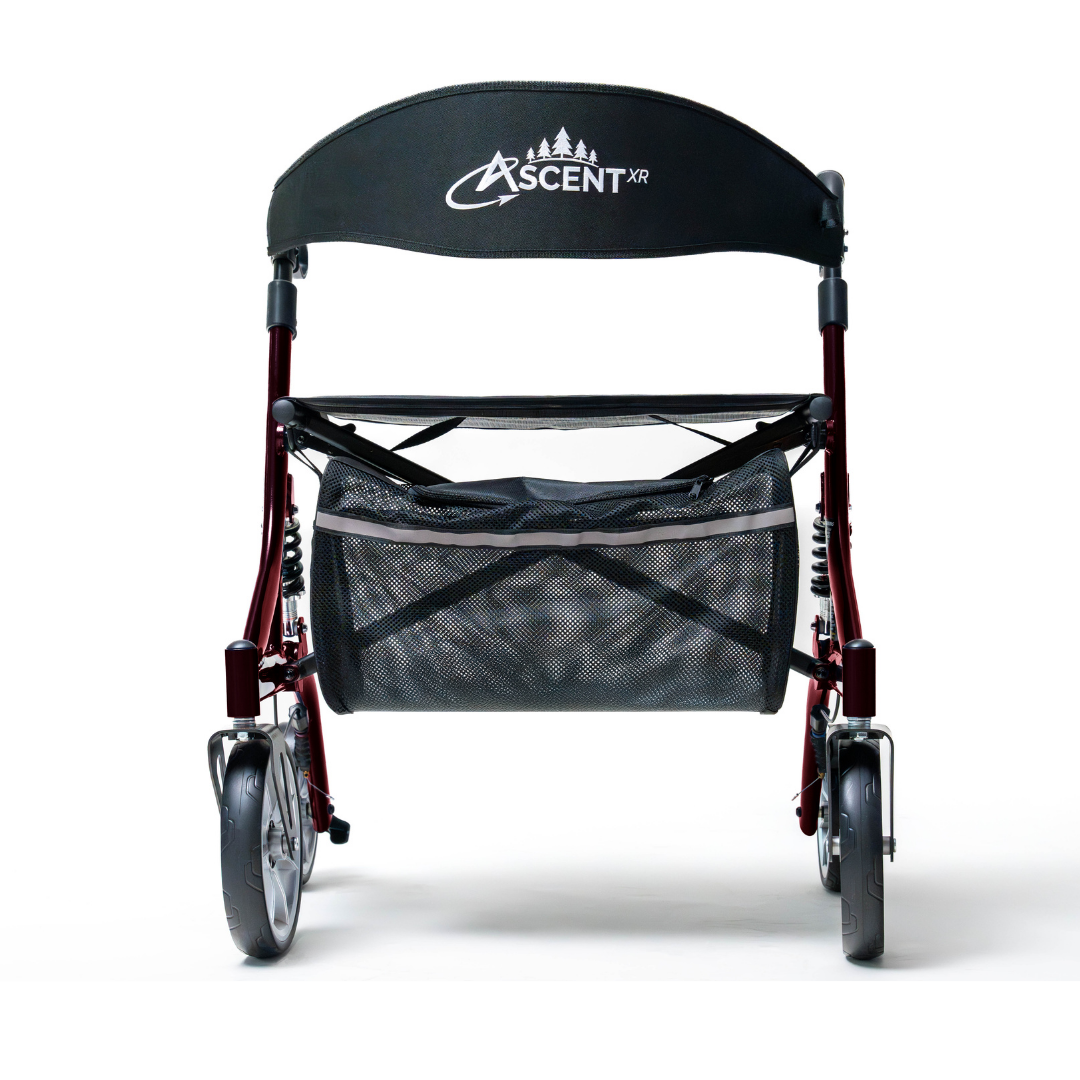 The Probasics Ascent XR™ Euro-Style Bariatric Rollator with Suspension is a lightweight, foldable rollator featuring ergonomic handlebars, a black ASCENT XR seat, mesh storage basket, and four wheels, shown from the front on a white background.