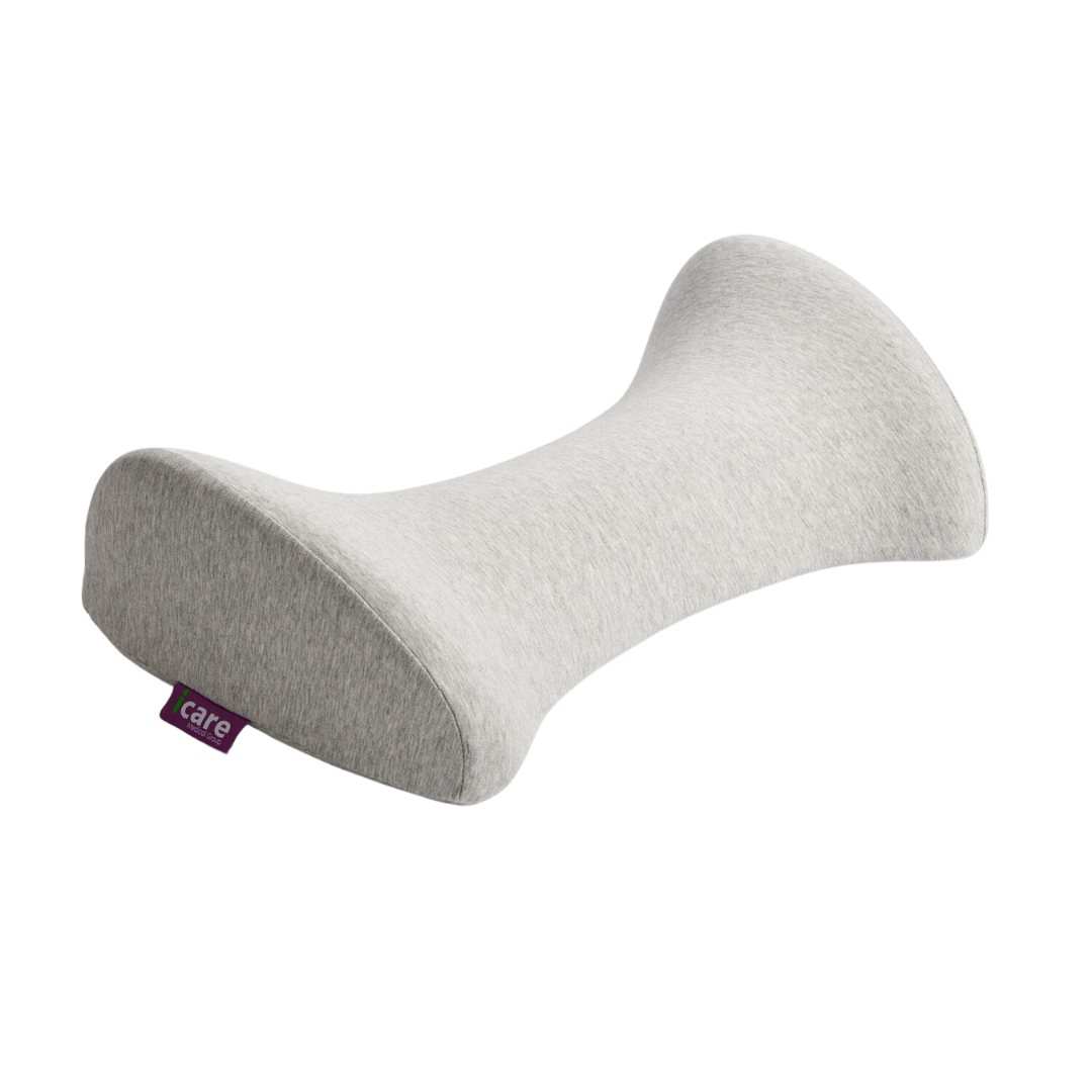 The iCare Reform Lumbar Support—bone-shaped and grey with a purple care tag—offers cradled relief for spinal alignment and back pain, shown on a white background.