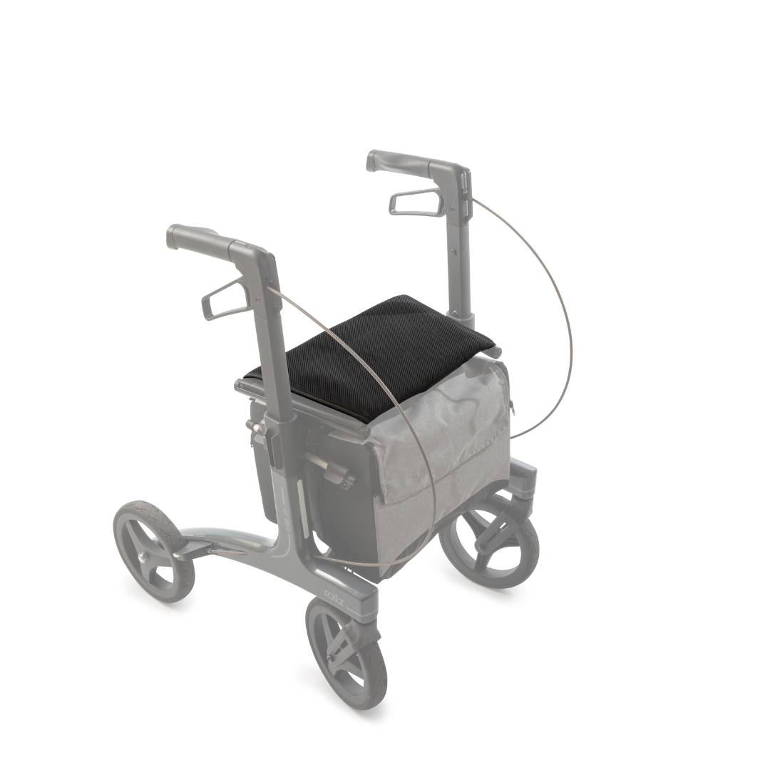 The Seat Cover for Rollz Air Rollator is shown on a white background, featuring a black seat cushion, ergonomic support, padded backrest, and a gray storage bag attached under the seat.
