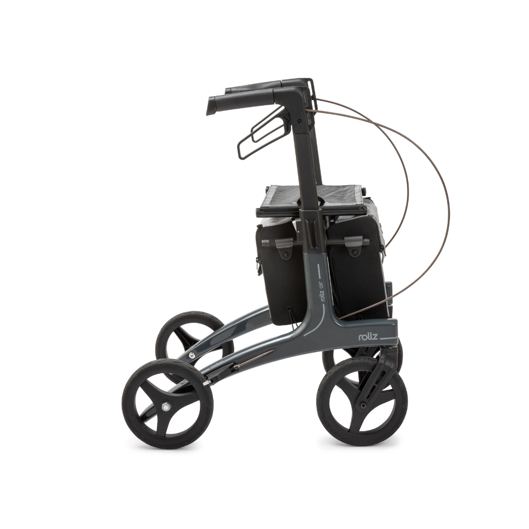 The Rollz Air Lightweight Folding Carbon Rollator, weighing just 10.4 lbs, features a modern black-and-gray design with four large wheels, ergonomic handles, seat, and storage bag—shown in side profile on a white background.