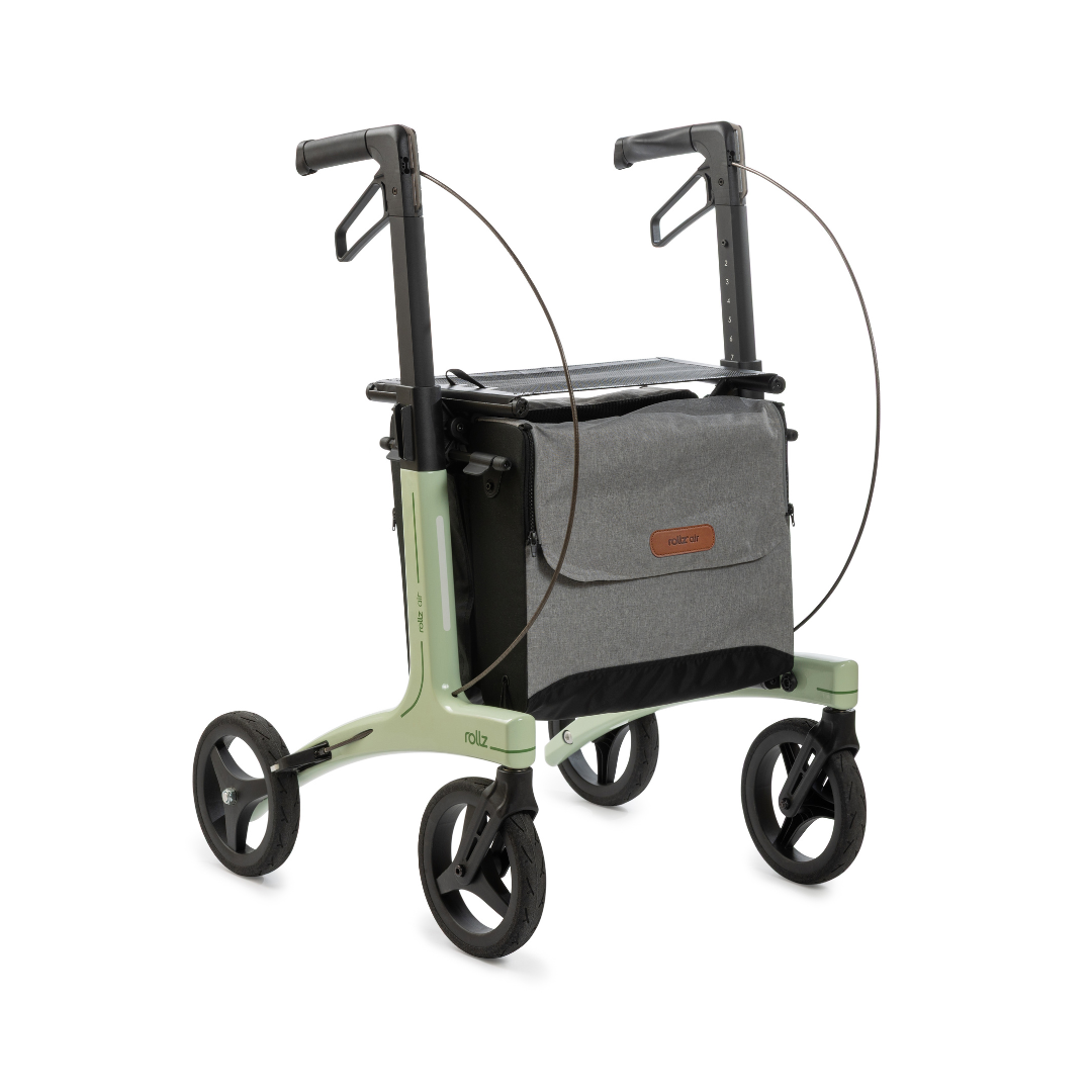 The Rollz Air Lightweight Folding Carbon Rollator, weighing just 10.4 lbs, features a modern design in light green, four large black wheels, adjustable handles, and a gray storage bag attached to its frame.