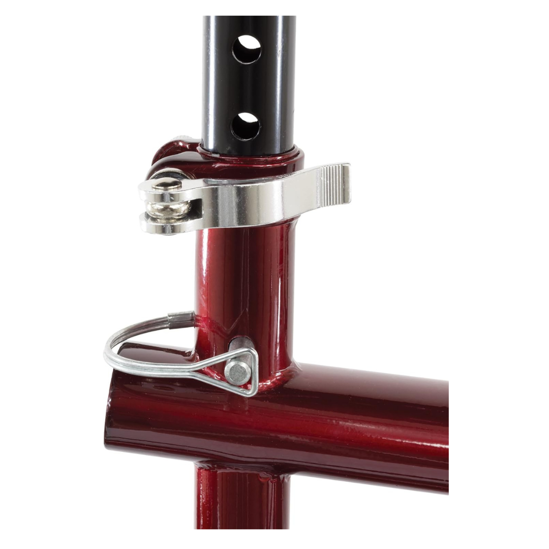 Close-up of the seat post clamp and quick-release lever on a red bike frame, featuring adjustment holes—similar to the Roscoe Portable Lightweight Rolling Knee Walker for easy height adjustment.