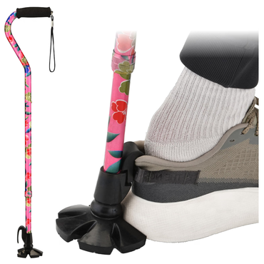 A Nova Walking Cane with Shoe Horn | 2-in-1 Shoe Helper & Walking Aid featuring a floral pattern and quad base is shown standing upright. Next to it, a person’s shoe and sock press down on the cane’s flexible base to demonstrate its stability and grip.