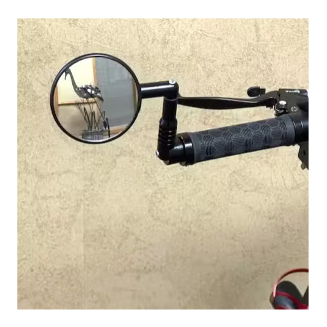 An ergonomic bicycle handlebar with a textured grip is shown, featuring a round rearview mirror for safety. The image includes the reflection of a Glion SNAPnGO Scooter against a plain light-colored wall.