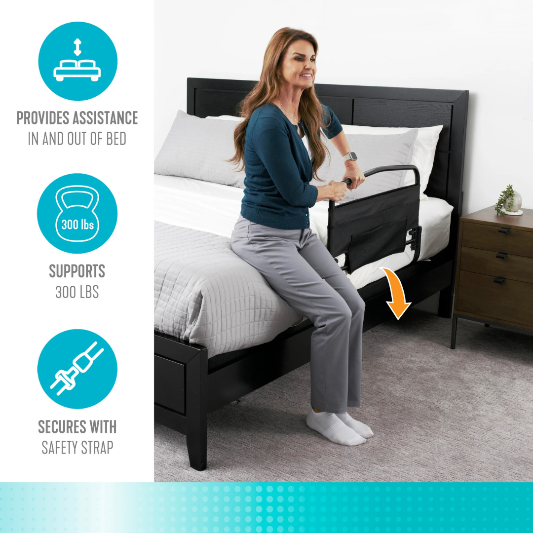 A woman uses the Stander Safety Bed Rail & Padded Pouch (30" rail) with a standing handle to sit on her bed. Infographics show it supports up to 300 lbs, offers fall protection, and secures with a safety strap for peace of mind.