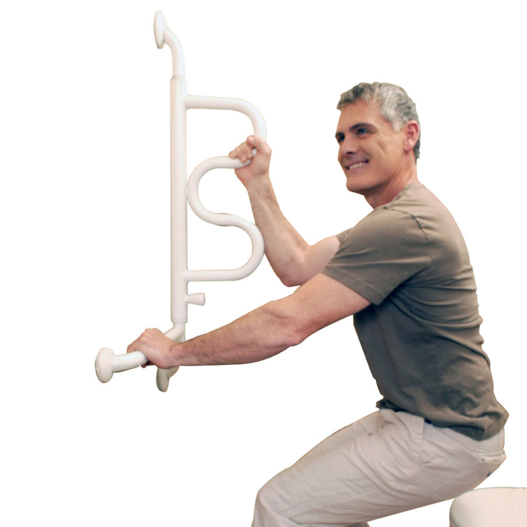 A gray-haired man smiles as he uses the Stander Curve Grab Bar – 180° Pivoting Arm, gripping it to help himself stand from a seated position against a plain white background.