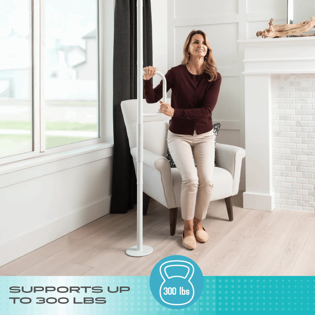 A woman uses the Stander Wonder Pole Lite—Fall Prevention Safety Pole for the Home—next to a chair in a bright living room. Text at the bottom reads, Supports up to 300 lbs, with a blue icon showing 300 lbs.