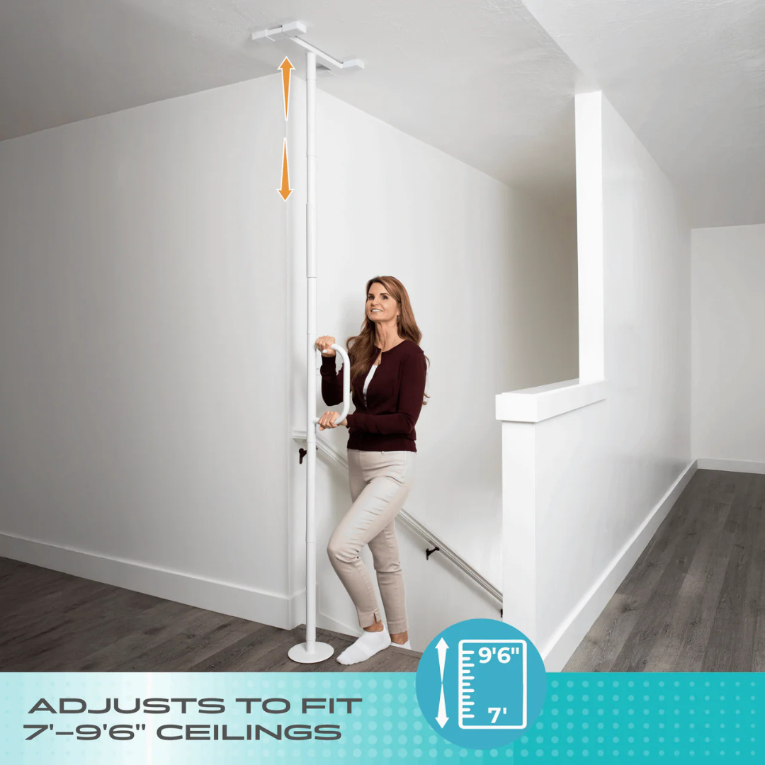 A woman demonstrates the Stander Wonder Pole Lite - Fall Prevention Safety Pole for the Home, an adjustable tension-mounted grab bar that fits ceilings from 7 to 9 feet 6 inches for secure bathroom safety support.
