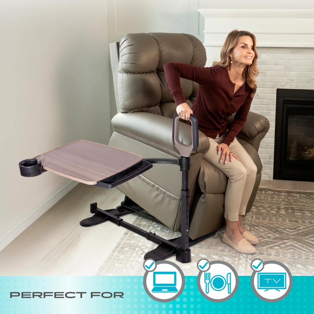 A smiling woman uses the Stander Wonder Tray Premium – XL TV Tray & Standing Aid, featuring a swiveling table while seated on a beige recliner. Icons highlight its use for meals, computer work, and watching TV.