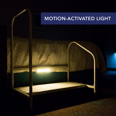 The Step2Bed Bedside Stepper with Fall Prevention Handles features a built-in motion-activated light that glows softly in the dark, enhancing safety near the bed. “MOTION-ACTIVATED LIGHT” is shown in a blue banner at the top right.