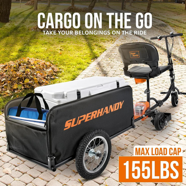 A black SuperHandy electric scooter with a SuperHandy Scooter Cargo Trailer sits on a leaf-covered path. The trailer, offering tool-free assembly and 155 lb max load, holds a cooler and bags. Text: Cargo on the go.