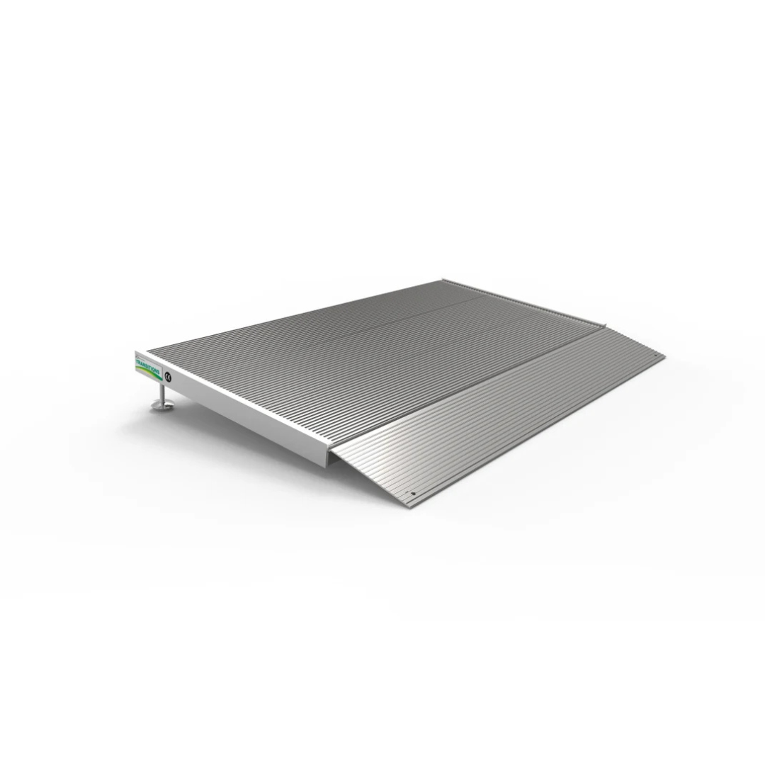 The EZ-Access TRANSITIONS® Angled Entry Ramp with Adjustable Legs is shown on a plain white background, featuring a flat, rectangular silver design with a textured surface. One end is raised to form a gentle incline, ideal for accessibility and loading.