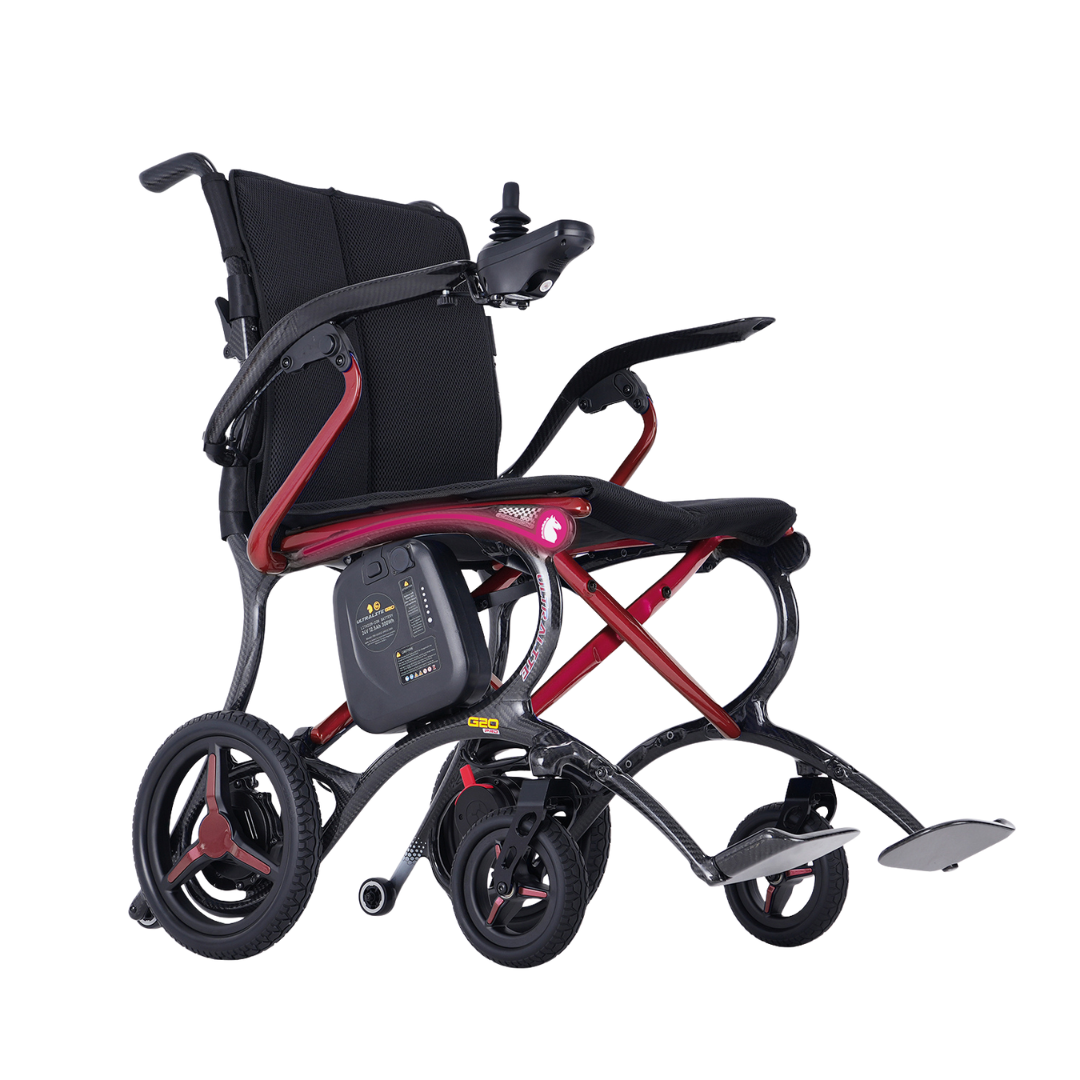 Lightweight and foldable, the Forcemech Ultralite G20 PRO Carbon-Fiber Power Wheelchair features a sleek black seat, durable red frame, joystick control conveniently mounted on the armrest, supportive footrest, and large rear wheels—all constructed from premium carbon-fiber materials to ensure exceptional strength and portability. The wheelchair is displayed at an angle against a crisp white background.