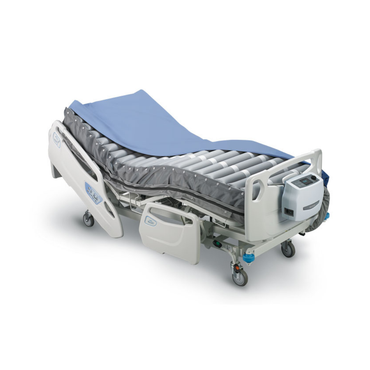 The Wellell Optima Auto Alternating Pressure and LAL System is a hospital bed setup with blue-gray bedding, side rails, wheels, and a control unit for automatic pressure adjustment to enhance patient comfort and care.
