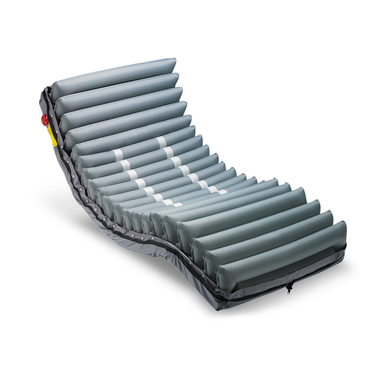 The Wellell Procare Elite Alternating Pressure Mattress with Micro Low Air Loss, in grey, features horizontal air tubes and is designed for hospital beds and pressure injury prevention, shown slightly elevated at the head and foot.