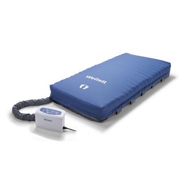 The Wellell Serene Air Alternating Pressure Mattress with True Low Air Loss, featuring a blue design and electronic control unit, helps prevent pressure injuries and manages moisture effectively in post-acute care settings.