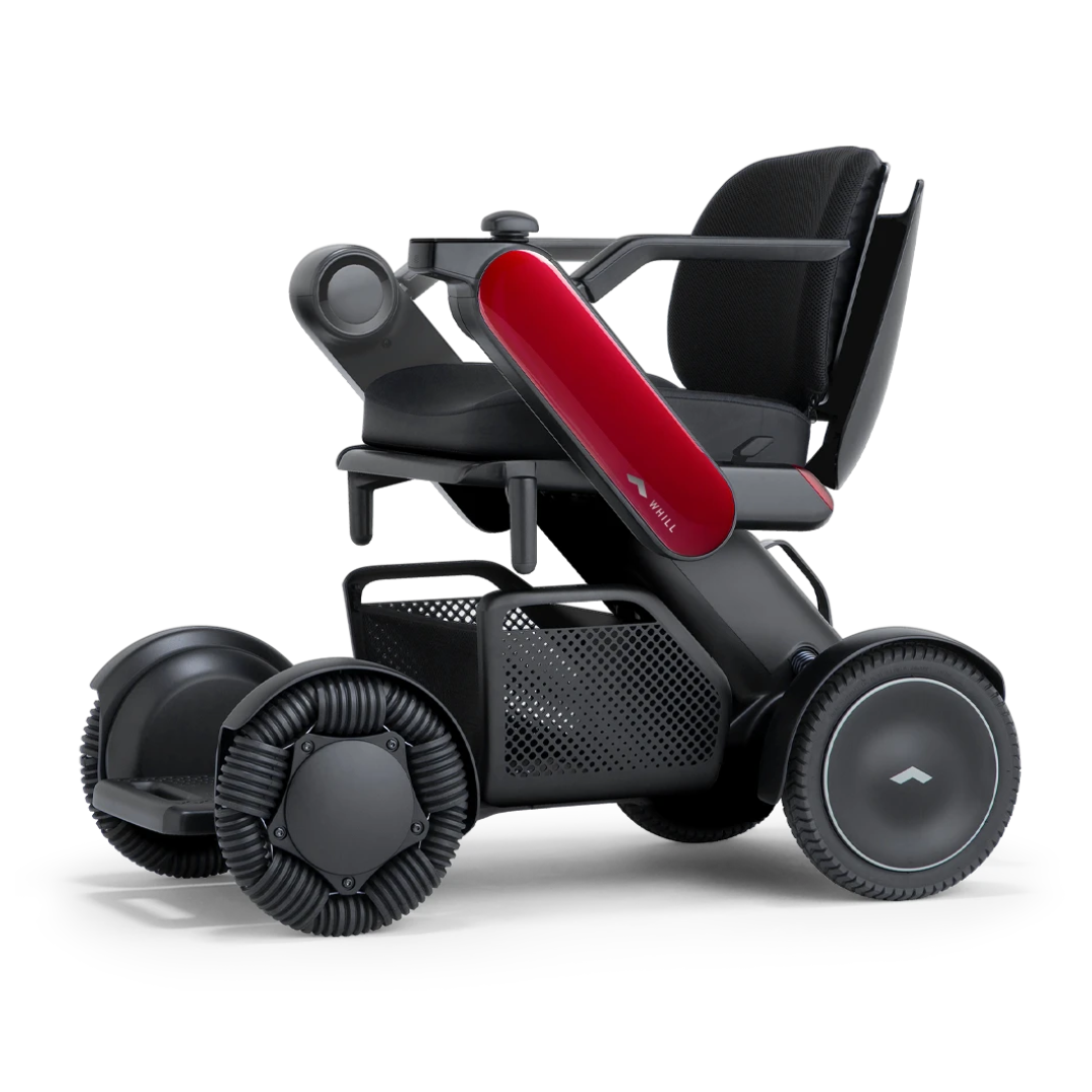 The Whill Model C2 Smart Power Chair is a compact, portable mobility device in black and red with unique wheels, mesh seat, storage basket under the seat, and is FDA-compliant as a Class II medical device for safety and reliability.