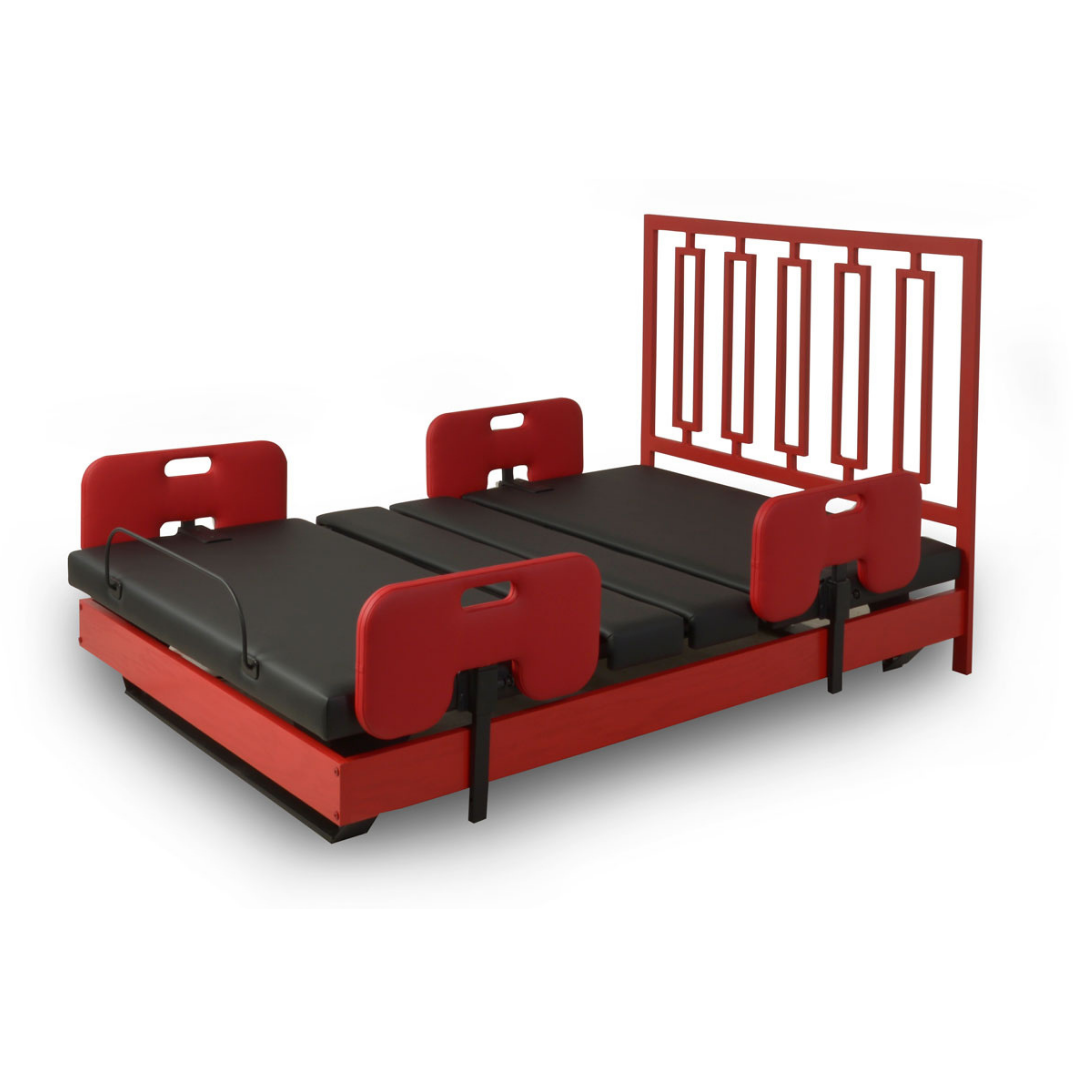 The Assured Comfort® Signature Series Hi-Low Adjustable Bed features a modern red frame, geometric headboard, black cushions, and four padded red side safety rails.