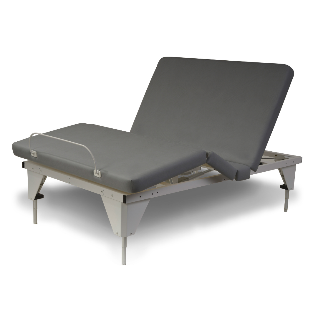 The Assured Comfort® Signature Series Hi-Low Adjustable Bed features a modern, minimalist design with a gray mattress elevated at the head and feet, a small metal guard rail near the foot, and four sturdy legs.