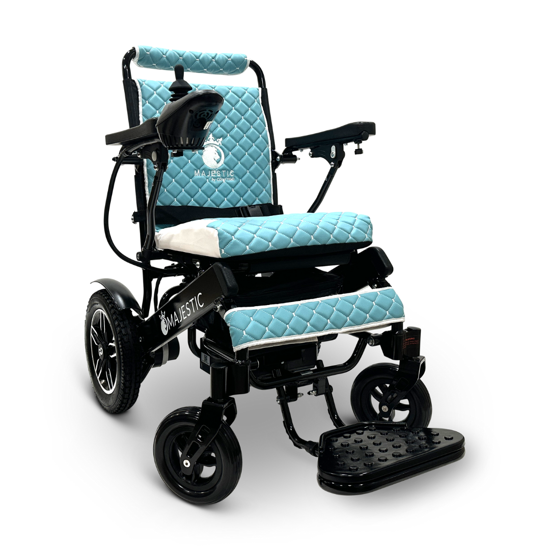 The ComfyGo MAJESTIC IQ-8000 is a black electric wheelchair that showcases blue quilted padding on both the seat and backrest. This travel-friendly, lightweight model features a joystick controller conveniently located on the armrest and large rear wheels, ensuring exceptional comfort and maneuverability.