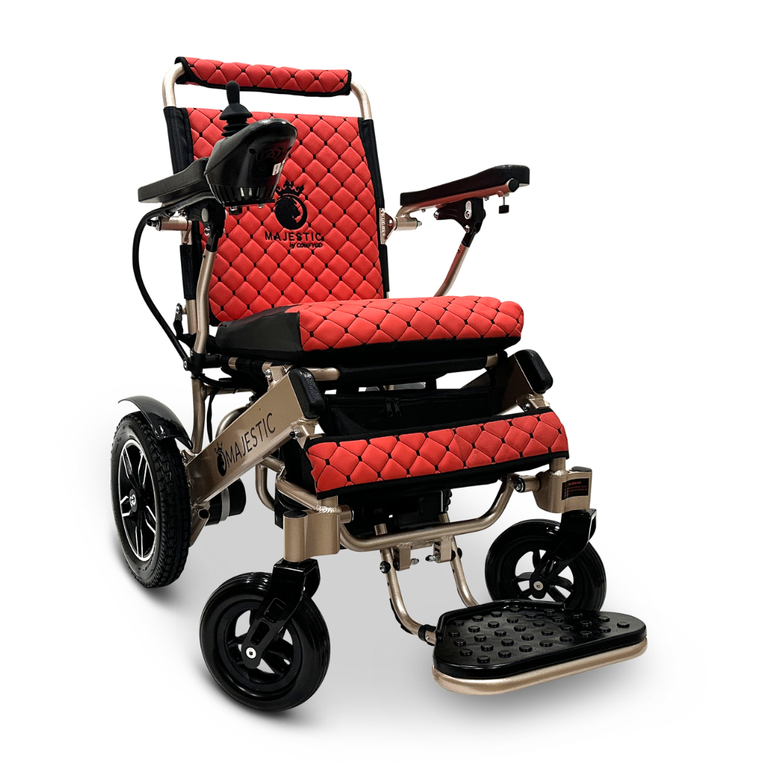 Introducing the ComfyGo MAJESTIC IQ-8000, a remote-controlled lightweight electric wheelchair featuring a striking red and black color scheme. It boasts a quilted seat design and includes a convenient folding footrest. Perfect for travel, this wheelchair is equipped with joystick control on the armrest and sturdy wheels for smooth mobility. Its metallic frame seamlessly combines modern style with practical functionality.