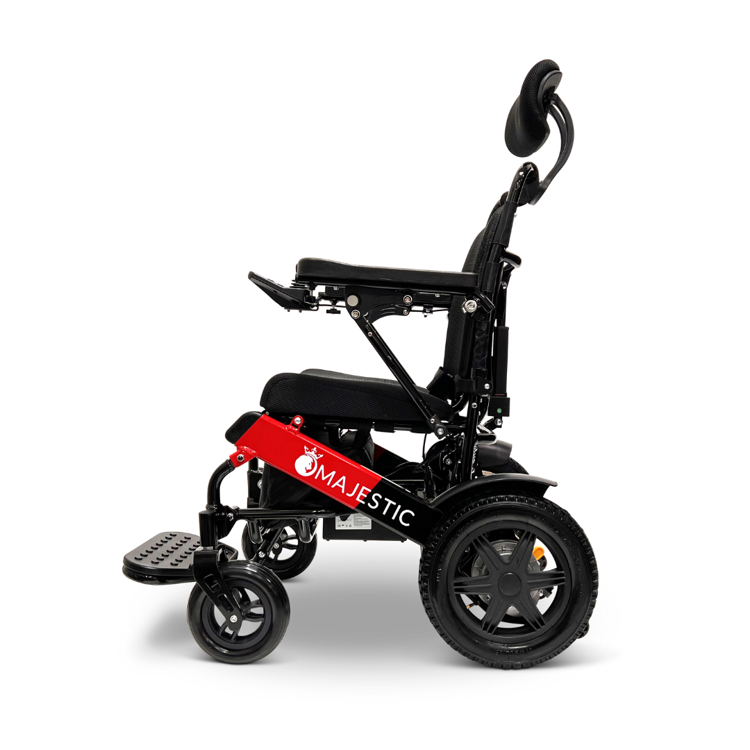 Side view of the ComfyGo MAJESTIC IQ-9000 Auto Recline Remote Controlled Electric Wheelchair, showcasing a sleek black motorized design with red accents and Majestic branding. This model includes a cushioned seat, headrest, footrest, digital joystick controller, and brushless silent motors to ensure enhanced mobility and comfort.