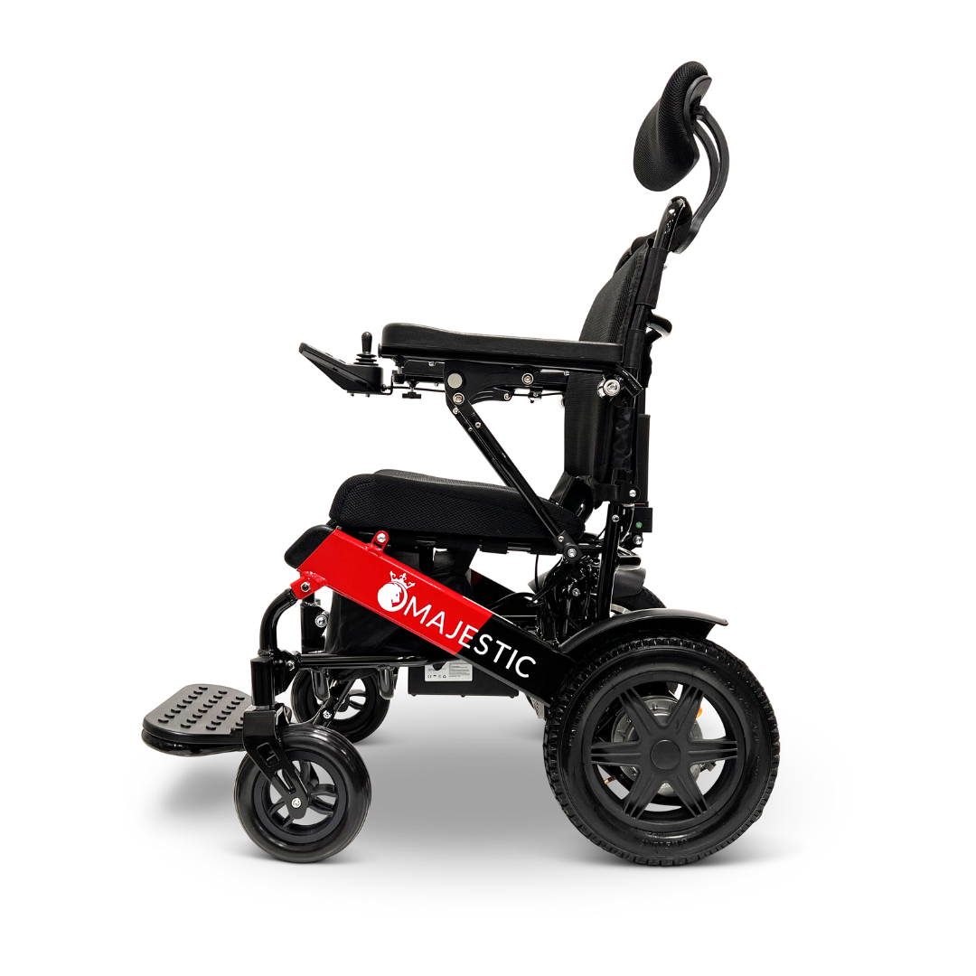The ComfyGo MAJESTIC IQ-9000 Auto Recline Remote Controlled Electric Wheelchair features large rear wheels, stylish smaller front wheels, and a digital joystick controller. Experience comfort with its padded seat, adjustable headrest, footplate, and brushless silent motors. The side prominently showcases the MAJESTIC brand name.