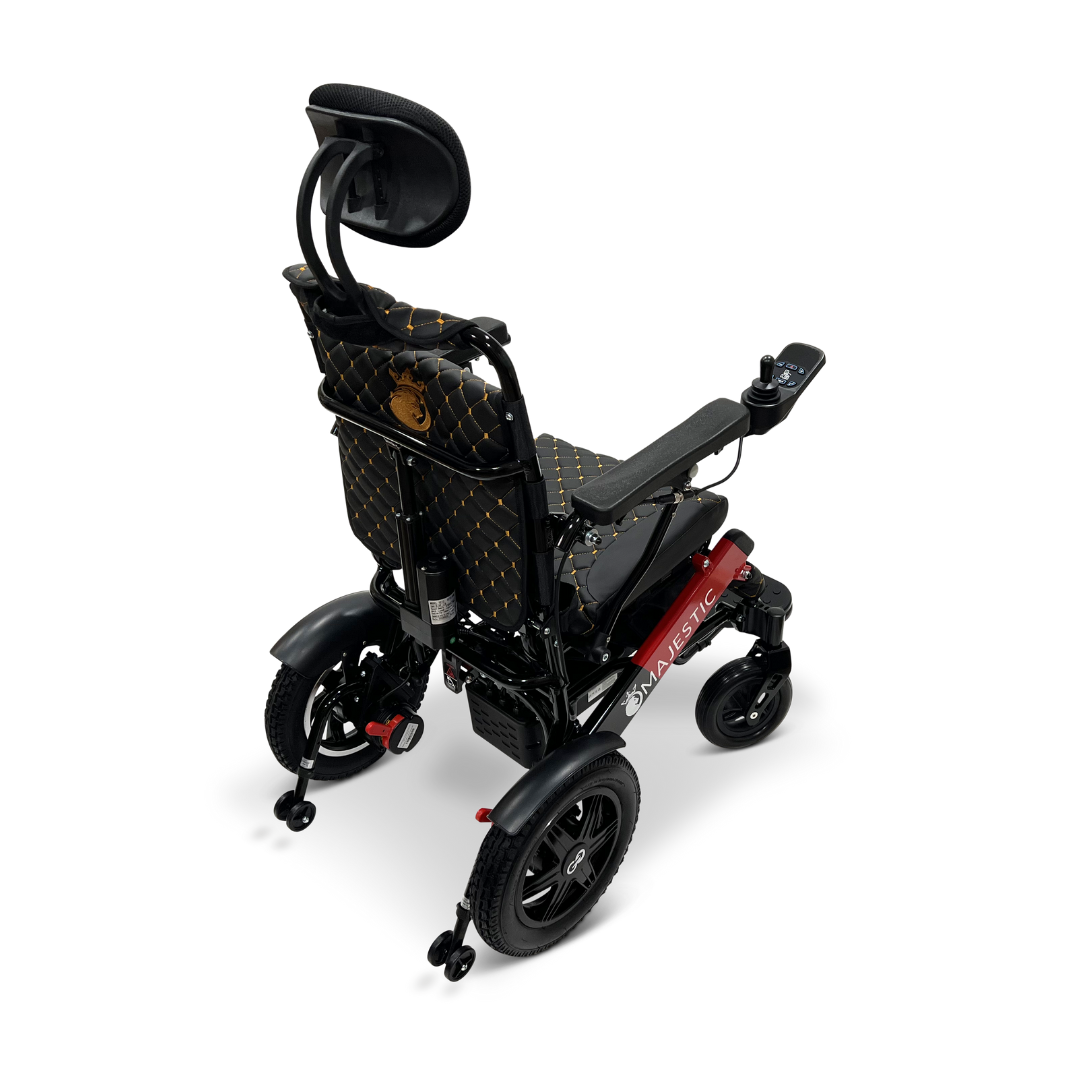 A ComfyGo MAJESTIC IQ-9000 Auto Recline Remote Controlled Electric Wheelchair in red and black features a foldable design with a quilted backrest, headrest, and armrests. From the rear view, it displays large rear wheels and smaller front wheels. It includes brushless silent motors and a digital joystick controller on the right armrest for easy navigation.