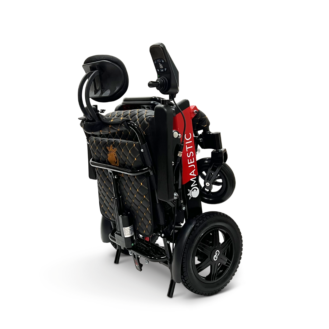 The ComfyGo MAJESTIC IQ-9000 is an electric wheelchair featuring a folded design, black quilted seat with red side accents, a digital joystick on the armrest, large black wheels for portability, and automatic reclining for comfort.