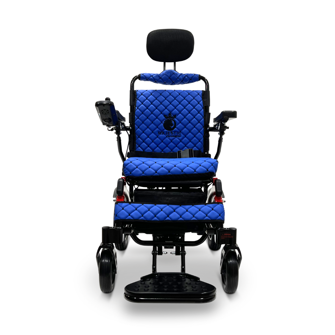The ComfyGo MAJESTIC IQ-9000 Auto Recline Remote Controlled Electric Wheelchair is a blue quilted electric model with a sleek black frame, featuring a headrest, footrest, and arm control panel. It includes brushless silent motors and a digital joystick controller for improved mobility. Large rear wheels and smaller front wheels provide comfort, while the brand name MURAT is displayed on the backrest.