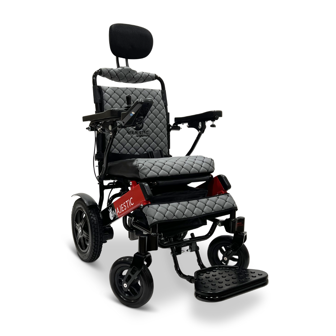 The ComfyGo MAJESTIC IQ-9000 Auto Recline Remote Controlled Electric Wheelchair, in red and black, boasts quilted gray cushions and adjustable armrests, footrest, and headrest. Equipped with sturdy wheels and brushless silent motors, the Majestic brand ensures a smooth ride using its digital joystick controller conveniently located on the side.