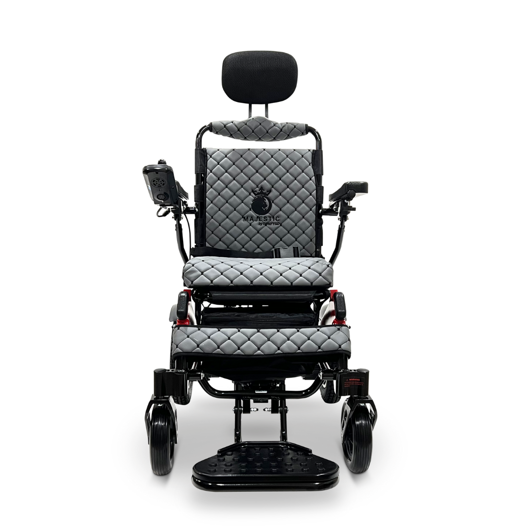 The ComfyGo MAJESTIC IQ-9000 Auto Recline Remote Controlled Electric Wheelchair features a sleek black frame and quilted gray cushions. It is equipped with a digital joystick controller and silent brushless motors, along with a headrest and footrest, seamlessly combining modern design with exceptional comfort and mobility.