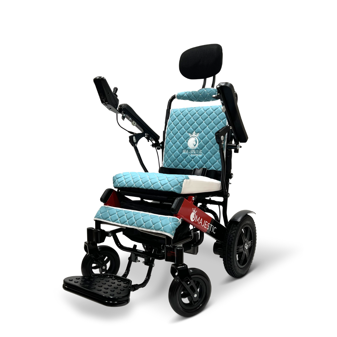 The ComfyGo MAJESTIC IQ-9000 Auto Recline Remote Controlled Electric Wheelchair showcases blue quilted cushions and an adjustable headrest, all set against a sleek black frame. It is powered by brushless silent motors, navigated with a digital joystick controller for seamless movement, and features the brand logo prominently on the backrest and footrest against a plain white backdrop.