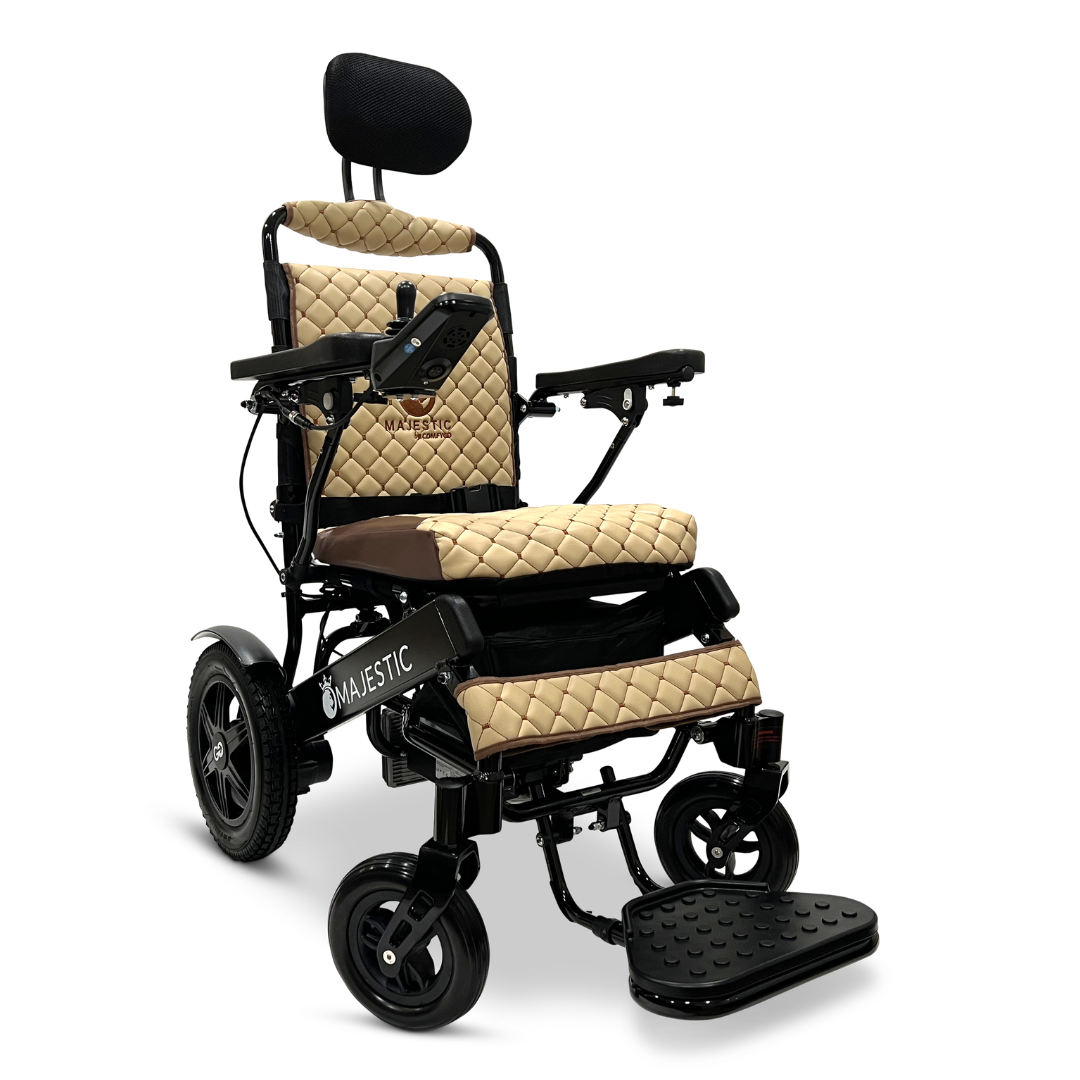 The ComfyGo MAJESTIC IQ-9000 Auto Recline Remote Controlled Electric Wheelchair in sleek black and beige features quilted cushions, adjustable armrests, and a footrest. It is equipped with a digital joystick controller and brushless silent motors to ensure smooth navigation. The headrest attaches elegantly to the top of the backrest against a white backdrop.