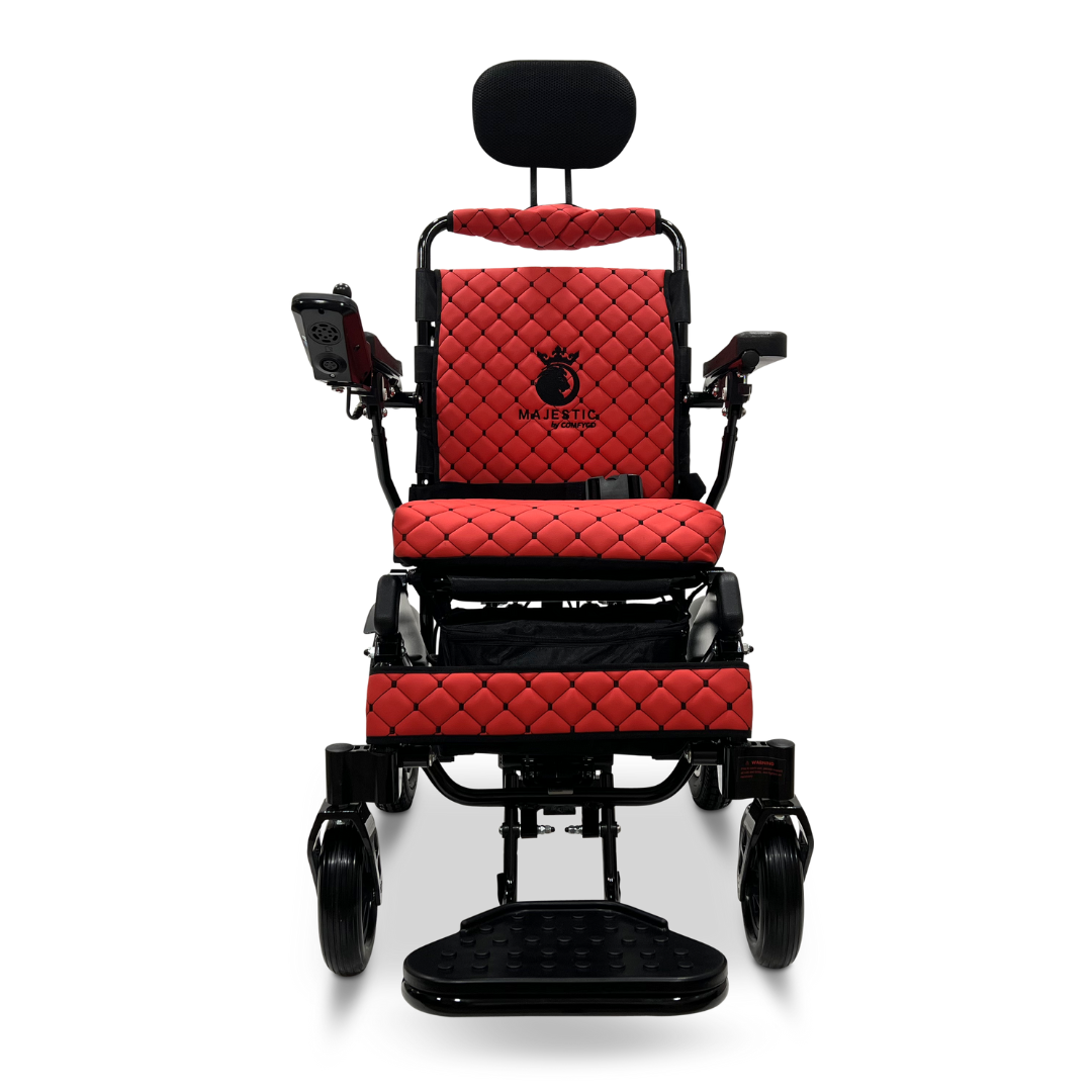 The front view features the red ComfyGo MAJESTIC IQ-9000 Auto Recline Remote Controlled Electric Wheelchair, adorned with a quilted seat design. It is fitted with a digital joystick controller and includes armrests, footrests, along with brushless silent motors to ensure smooth operation. The Majestic logo embellishes the backrest, while its black wheels and metallic frame provide an elegant touch.