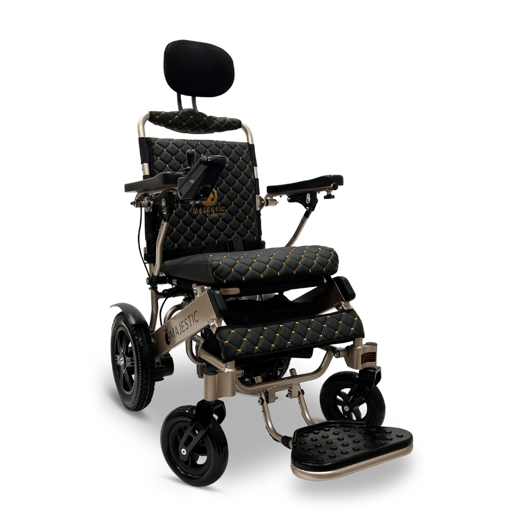 Introducing the ComfyGo MAJESTIC IQ-9000 Auto Recline Remote Controlled Electric Wheelchair: a stylish, black power wheelchair enhanced with gold accents. It features a quilted seat and backrest, adjustable armrests, and footplate for added comfort. Equipped with brushless silent motors and a digital joystick controller, it ensures smooth maneuverability. The padded headrest and sturdy frame add to its modern design.