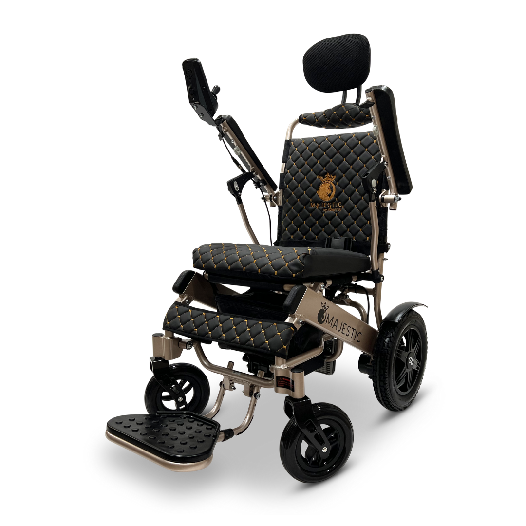 The ComfyGo MAJESTIC IQ-9000 Auto Recline Remote Controlled Electric Wheelchair exudes luxury with its black and gold quilted leather design. It features a padded headrest, adjustable armrests, and a foldable footrest for enhanced comfort and style, while the digital joystick controller and brushless silent motors offer a smooth ride.
