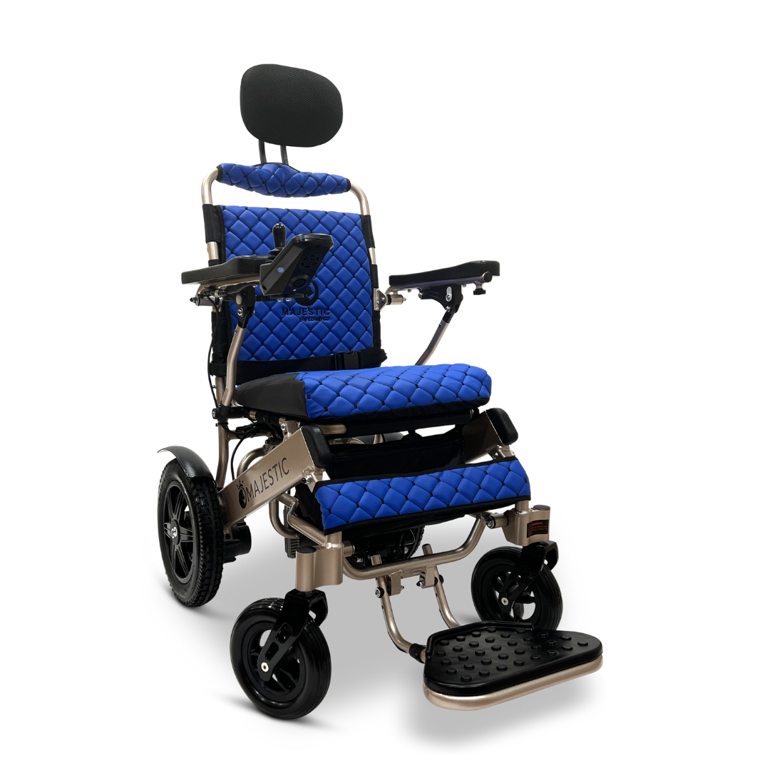 Introducing the ComfyGo MAJESTIC IQ-9000 Auto Recline Remote Controlled Electric Wheelchair: a modern marvel featuring brushless silent motors for a smooth ride. It boasts a blue quilted seat and backrest, complemented by black headrest and armrests, along with a digital joystick controller. Its sleek design is enhanced by sturdy black wheels and a textured footrest.
