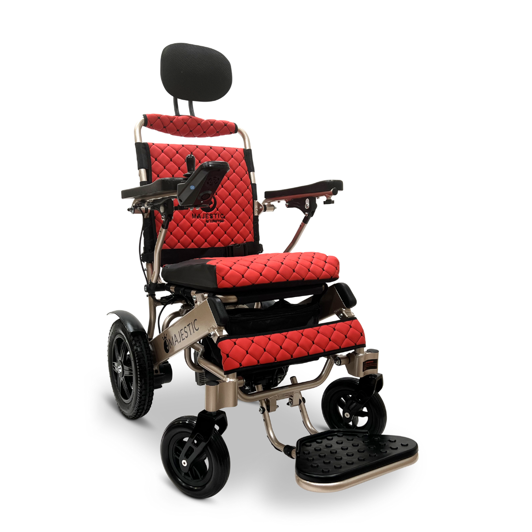 Introducing the ComfyGo MAJESTIC IQ-9000 Auto Recline Remote Controlled Electric Wheelchair: a stylish red and black electric wheelchair featuring a cushioned seat and backrest. It is equipped with brushless silent motors, adjustable armrests, and headrest for optimal comfort, as well as a footrest. The digital joystick controller provides precision control, while large rear wheels enhance mobility.