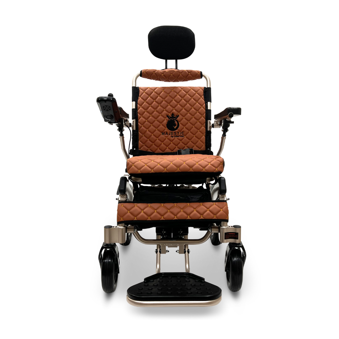 The ComfyGo MAJESTIC IQ-9000 Auto Recline Remote Controlled Electric Wheelchair is an elegant brown and black electric model, featuring a diamond-stitched leather seat and backrest complemented by a sleek black headrest. It comes with adjustable armrests and a footrest, and includes a digital joystick controller for effortless navigation with its brushless silent motors.
