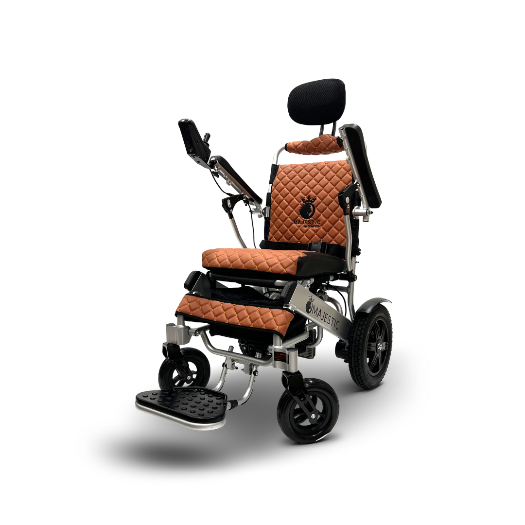 The ComfyGo MAJESTIC IQ-9000 Wheelchair features quilted brown cushions with black armrests and footrest, large rear wheels, smaller front wheels, an extendable headrest with auto-recline, and a digital joystick on the right armrest.
